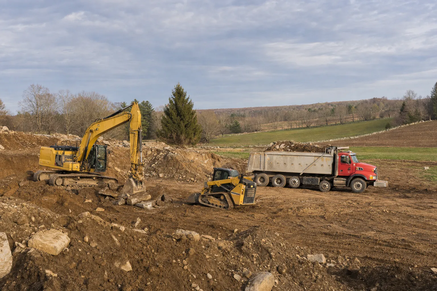 Excavation crew and equipment working on a job site in Pomfret, Connecticut