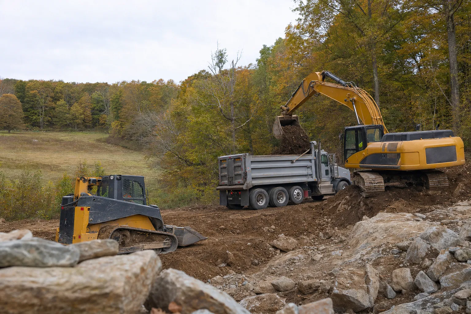 Excavation crew and equipment working on a job site in Woodstock, Connecticut